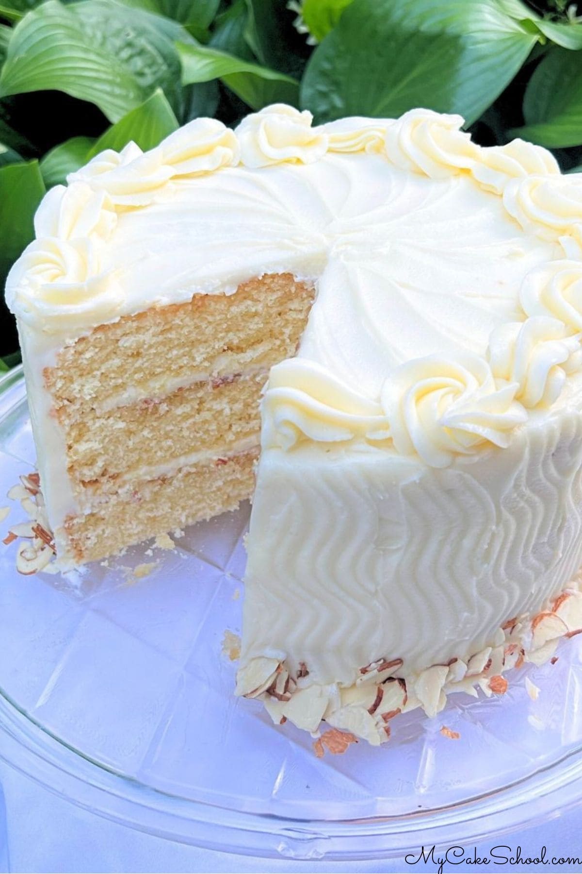 Amaretto cake, sliced, on a cake plate.