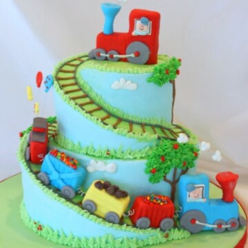 Learn how to carve spiral cake tiers in this train themed cake video tutorial! MyCakeSchool.com.