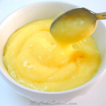 Bowl of lemon curd with a spoon.