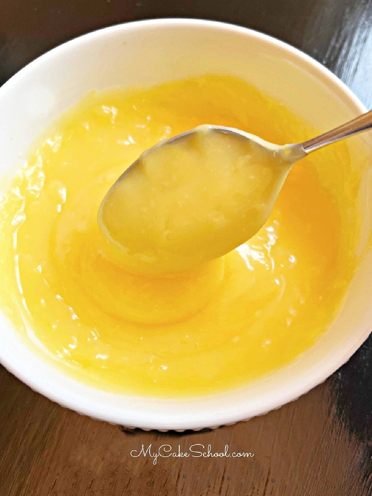 Bowl of Lemon Curd with a spoon.