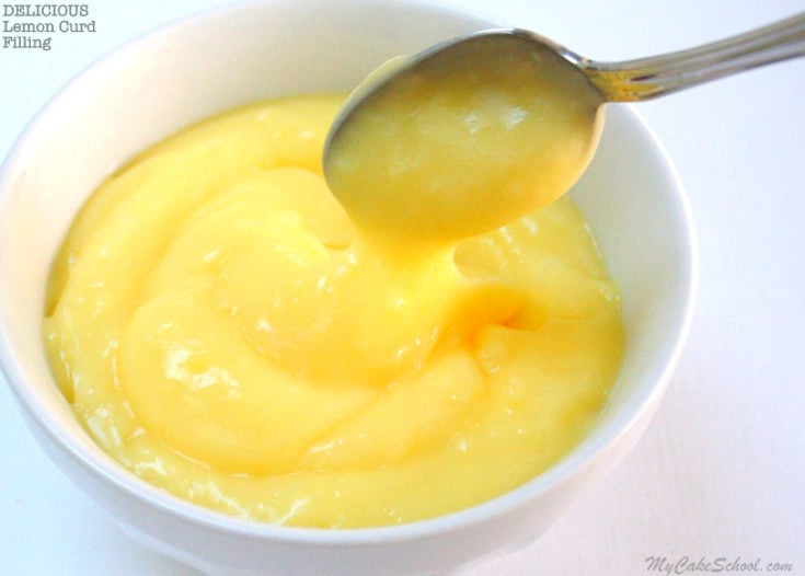 Lemon curd in a white bowl with a spoon