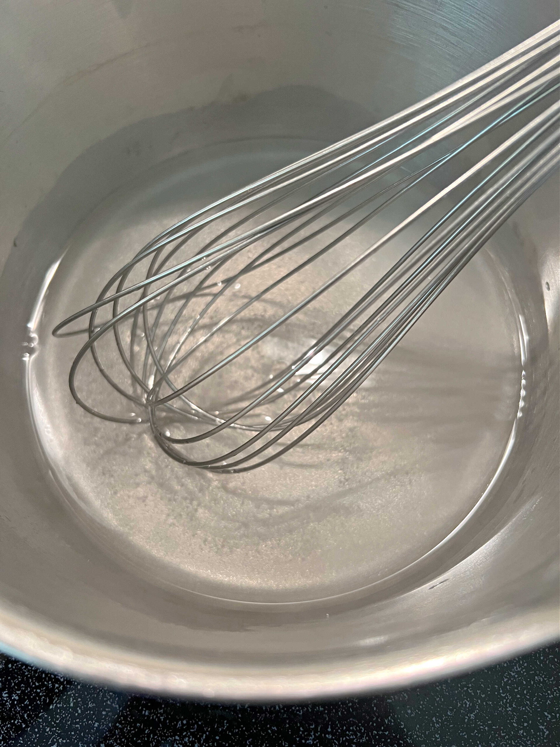 Saucepan with whisk, sugar,cornstarch, and water