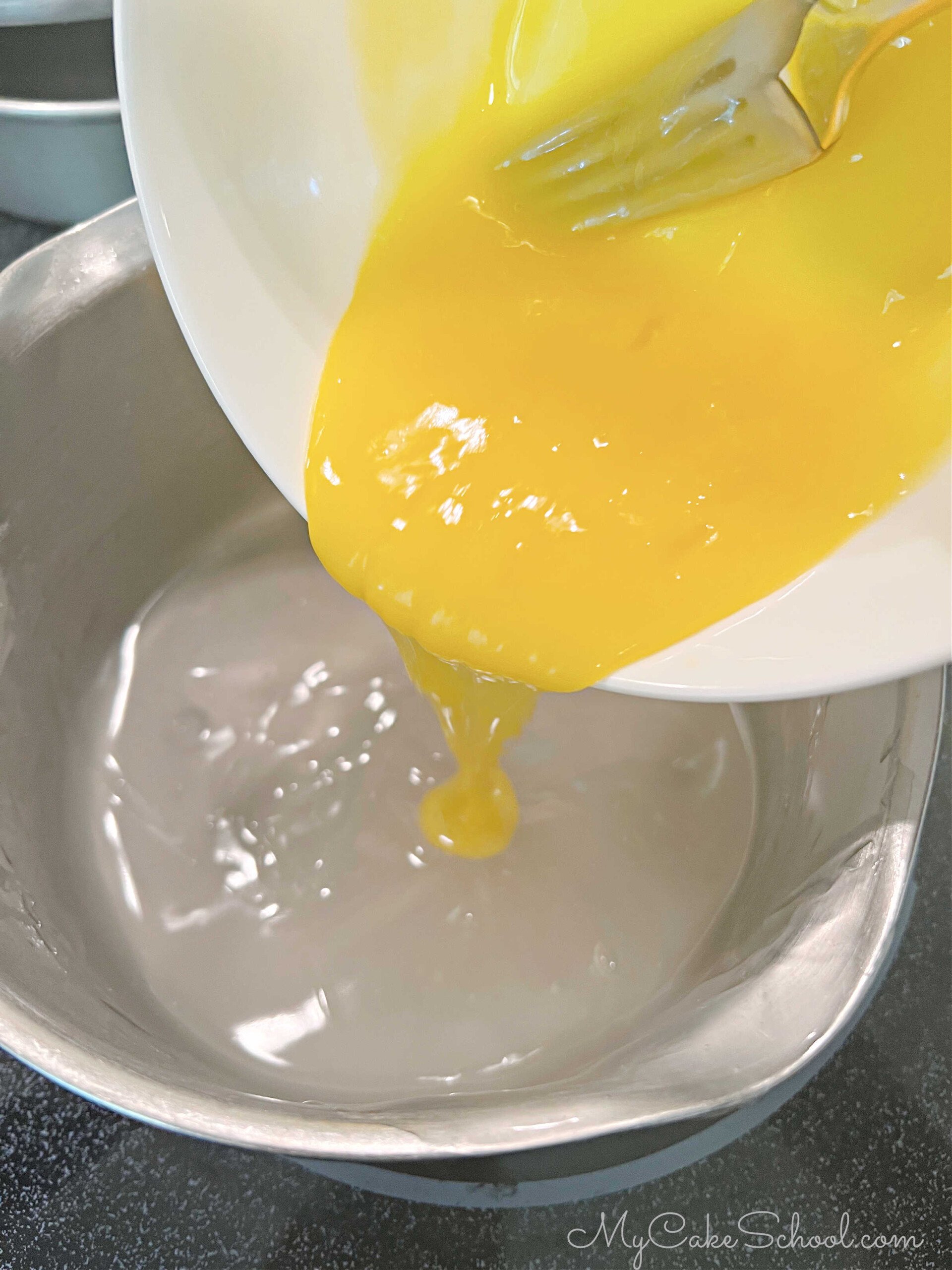 Pouring egg mixture into cornstarch, sugar, and water mixture.