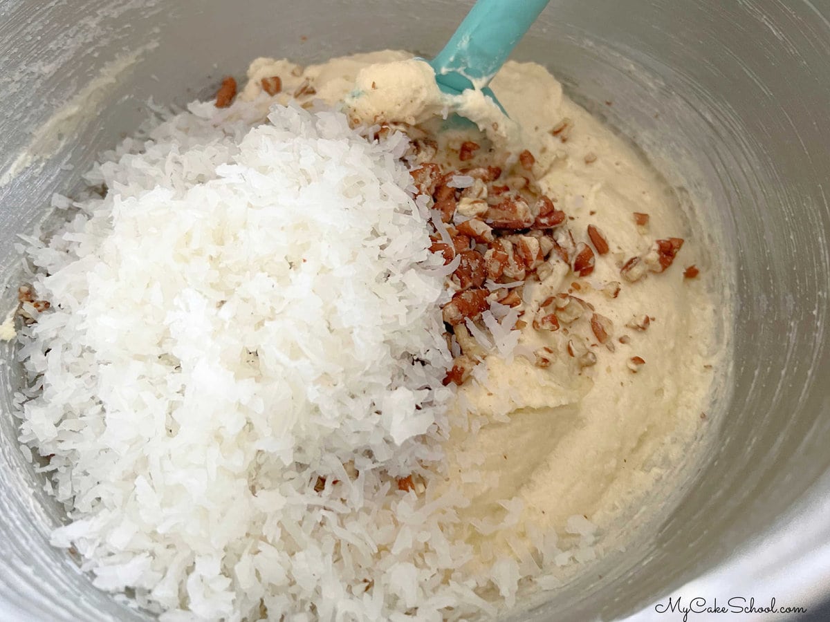 Folding coconut and pecans into the cake batter