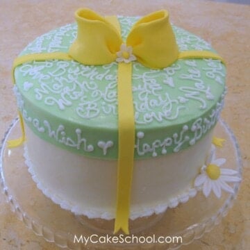 How to Make a Hat Box Cake with a Frosted Lid! Free step by step cake decorating tutorial by MyCakeSchool.com!