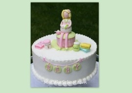 Learn to make this adorable mommy-to-be cake topper as well as this cute "Pickles and Ice Cream" themed baby shower cake in MyCakeSchool.com's cake decorating member video library.