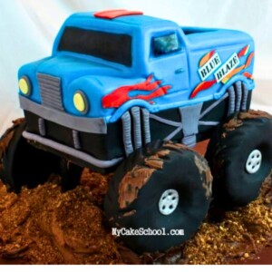 Photo of blue fondant covered monster truck cake with red flames on the side.