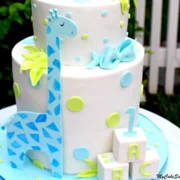Learn how to make a double barrel cake with sweet giraffes in this MyCakeSchool.com video tutorial! Perfect for young birthdays and baby showers! MyCakeSchool.com.