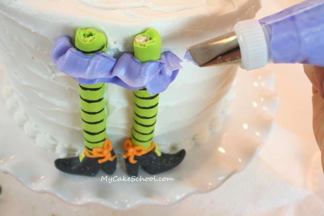 Free Tutorial for a CUTE Halloween Party Cake featuring witch legs and brooms! So fun and festive! MyCakeSchool.com 