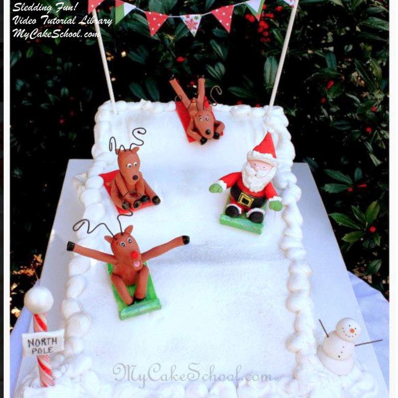 Adorable "Sledding into Christmas" Cake Tutorial! Learn to make Santa and reindeer toppers as well as a sledding scene in this My Cake School video tutorial!