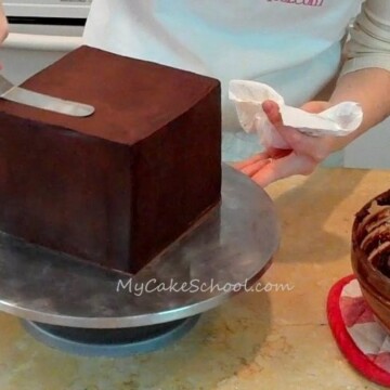 Learn how to ganache a square cake with straight edges and sharp corners! Tutorial by MyCakeSchool.com.