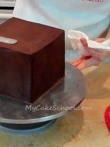 Learn how to ganache a square cake with straight edges and sharp corners! Tutorial by MyCakeSchool.com.