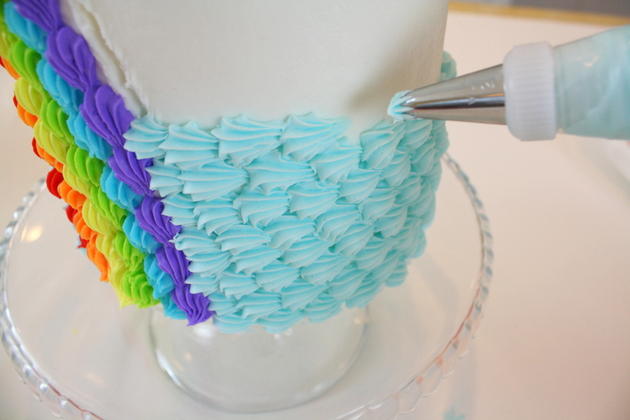 This Buttercream Rainbow Cake Tutorial is SO festive and cheerful! Easy to create with simple buttercream piping techniques! MyCakeSchool.com.