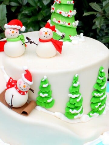 Sledding Snowman Cake! An adorable cake design for Christmas or winter. Tutorial by MyCakeSchool.com!