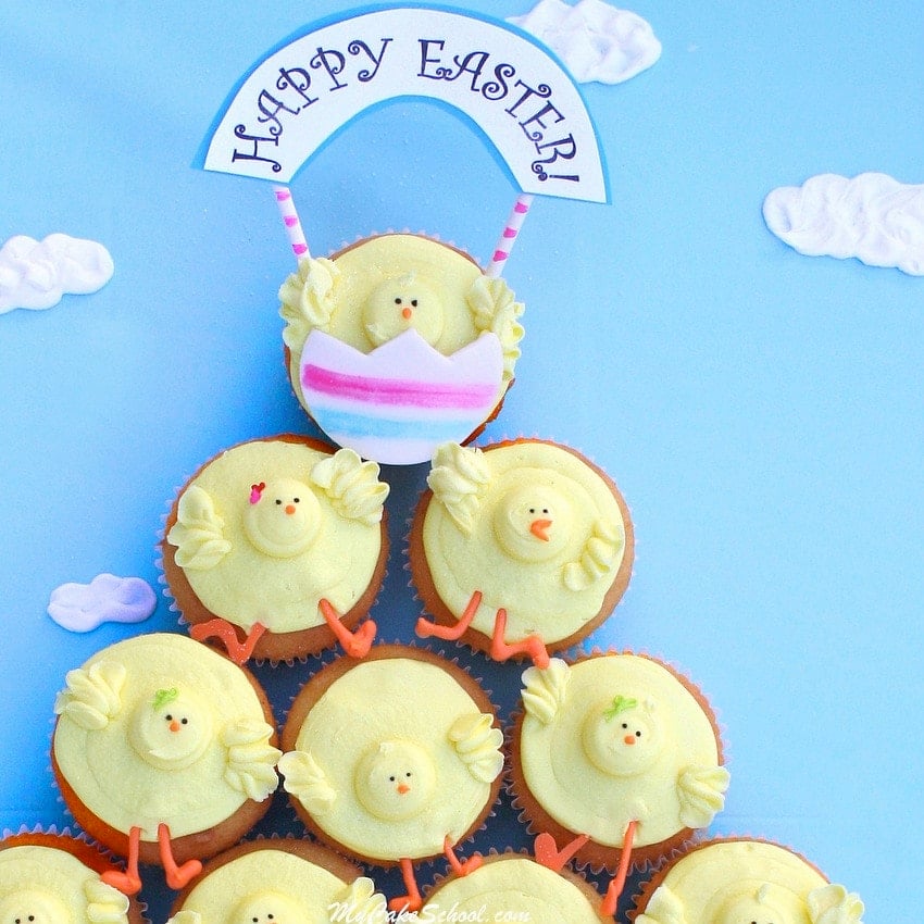 Chick Cupcakes arranged in a pyramid design on a cake board