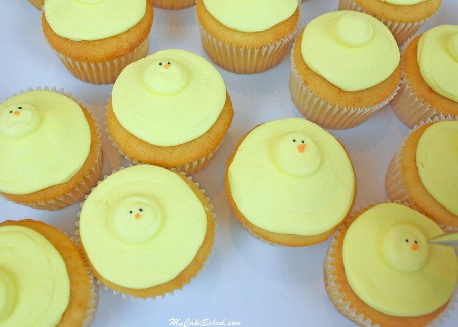 Piping on the beaks of the buttercream chick cupcakes