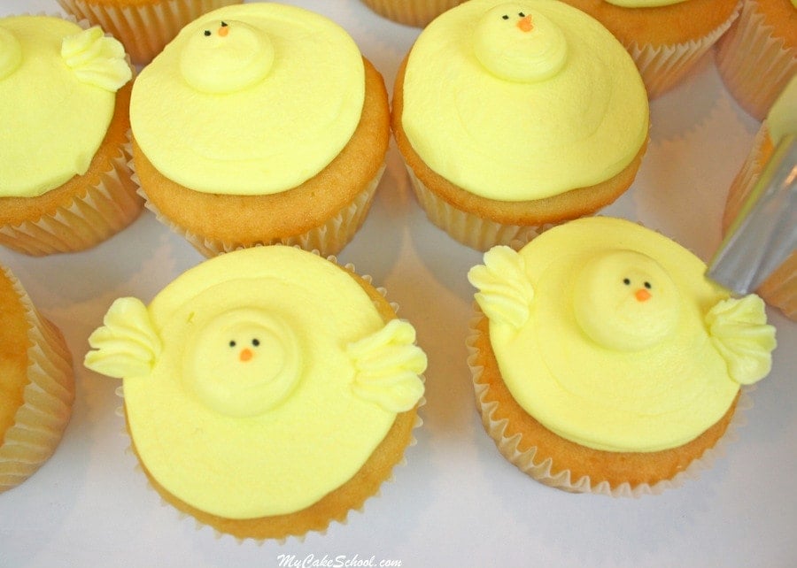 Piping on the wings of the buttercream chick cupcakes