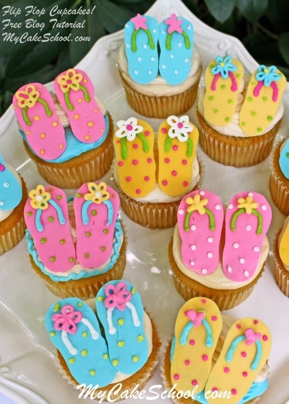 Platter of cupcakes, topped with flip flop cupcake toppers.