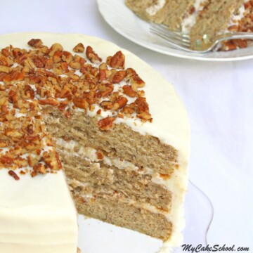 Sliced Banana Cake with Cream Cheese Frosting, on a glass pedestal.