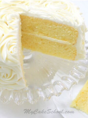 Lemon Cake from Scratch, sliced, on a cake pedestal.
