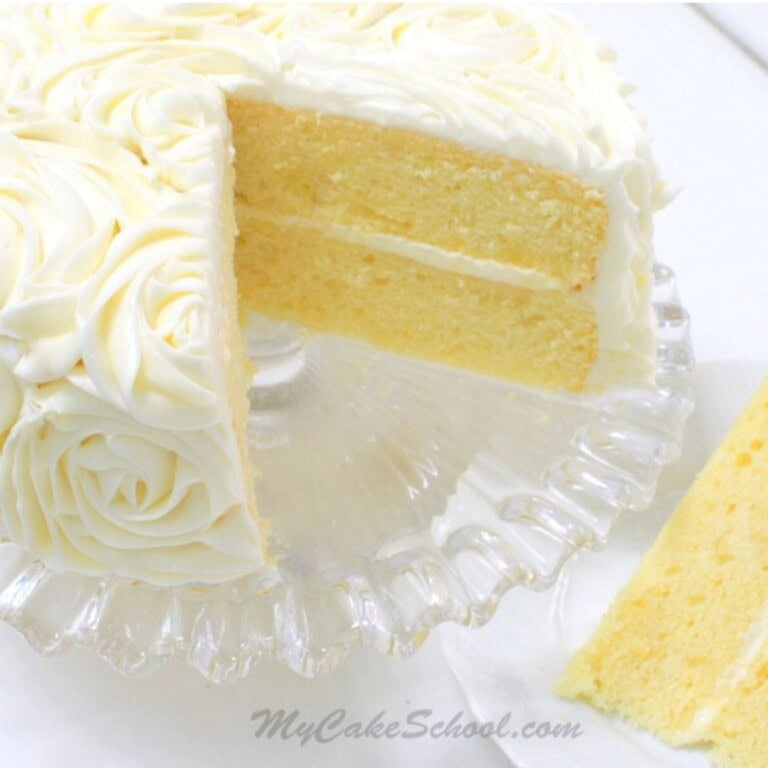 Lemon Cake from Scratch, sliced, on a cake pedestal.