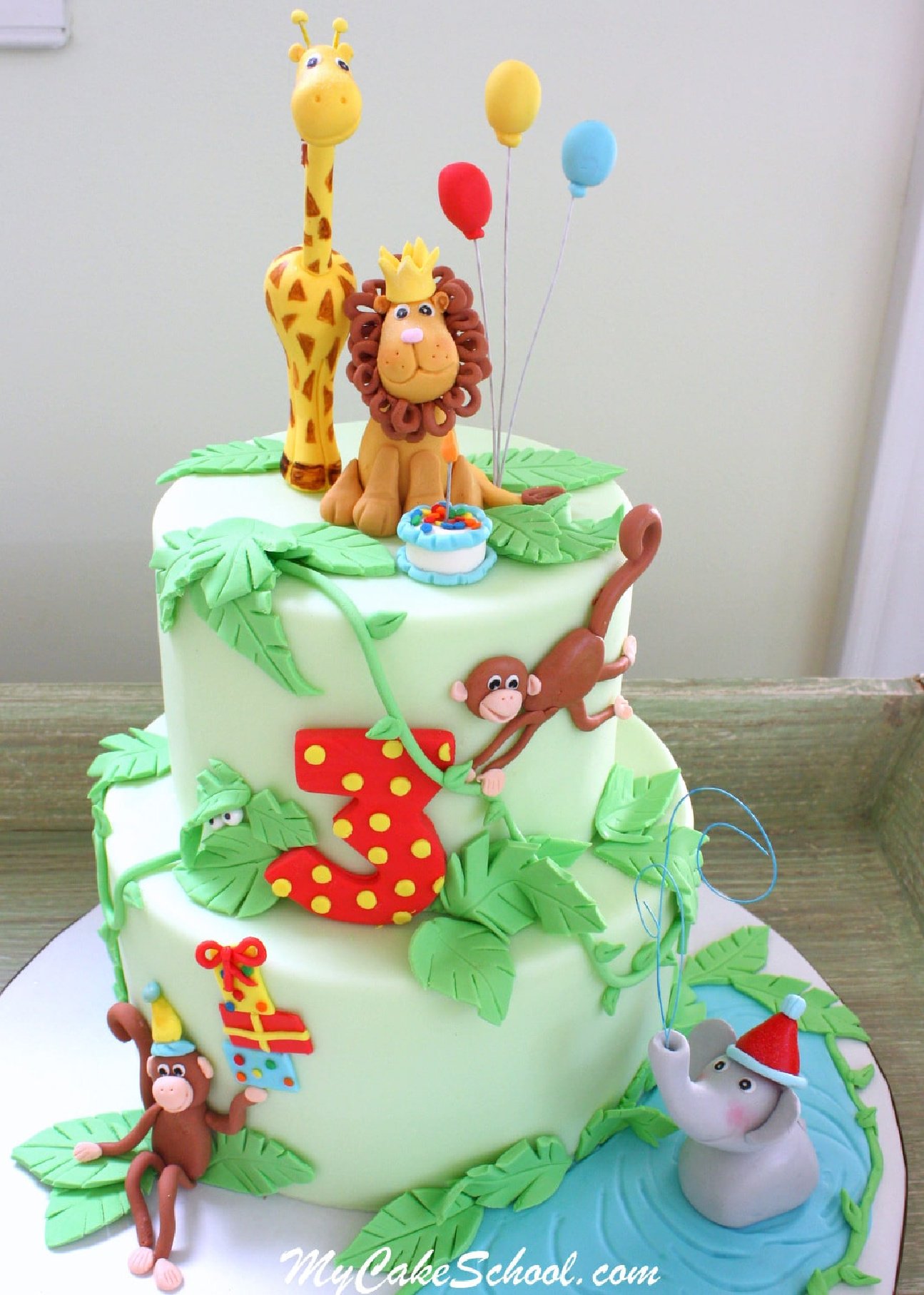 Jungle Cake with fondant jungle animals (giraffe and lion, monkeys and elephant)