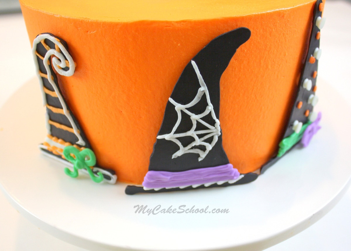 The perfect Halloween Cake! This witch themed cake design is so simple to make. Free Cake Tutorial by MyCakeSchool.com! Adorable Free Halloween Cake Tutorial by MyCakeSchool.com, featuring witch hat decorations! Perfect for Halloween parties!