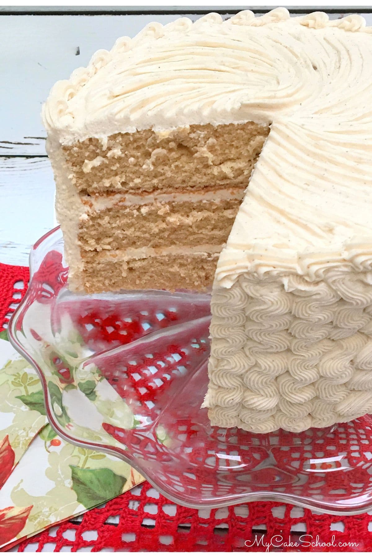 Sliced Eggnog Cake on a pedestal.