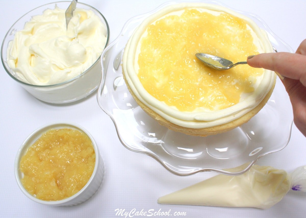 Amazing Piña Colada Cake Recipe from scratch! Moist and delicious coconut cake layers, pineapple filling, Piña Colada Cream Cheese Frosting, and a hint of rum! YUM! 