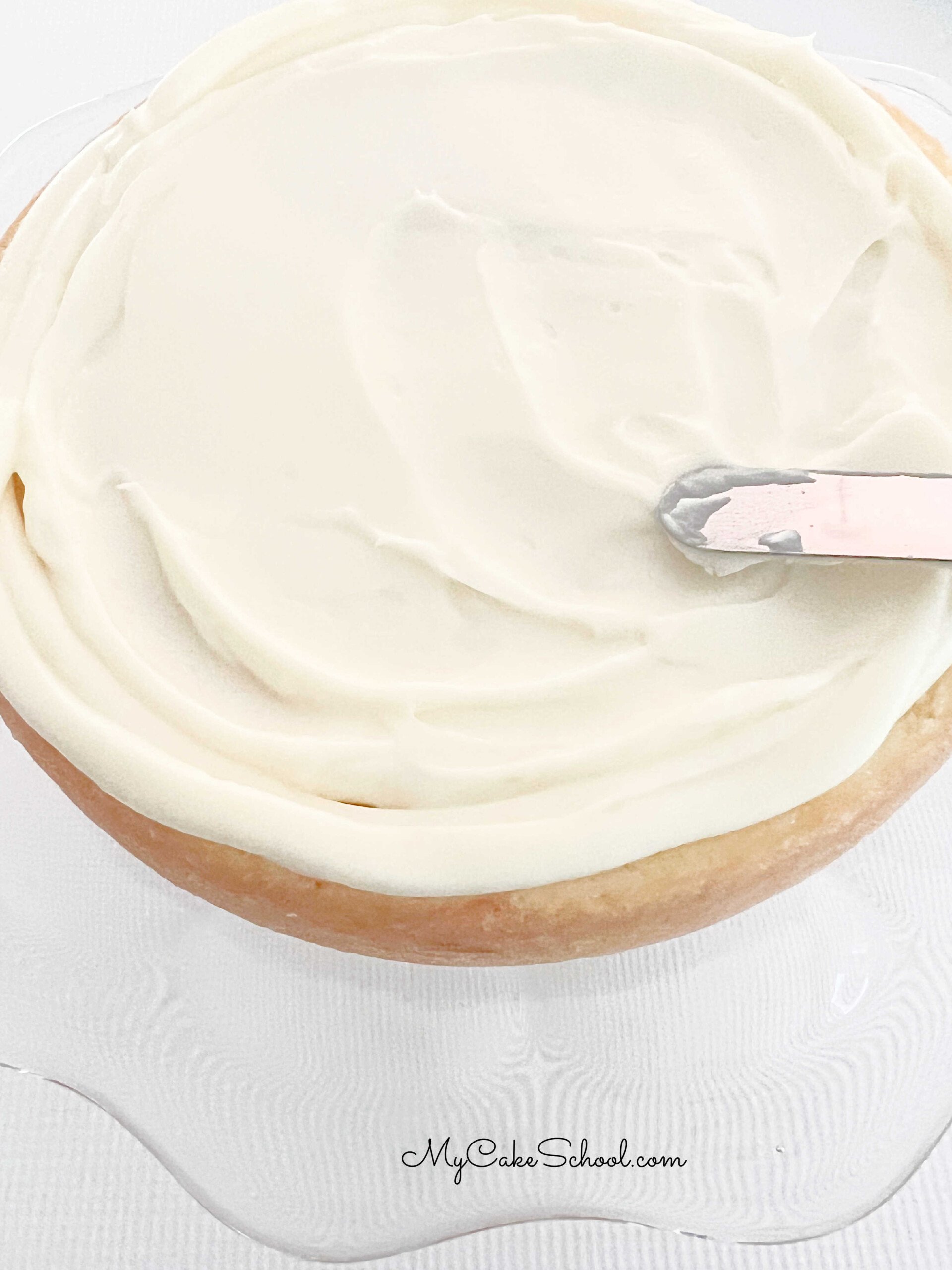 Spread pina colada cake layer with a layer of coconut rum cream cheese frosting.