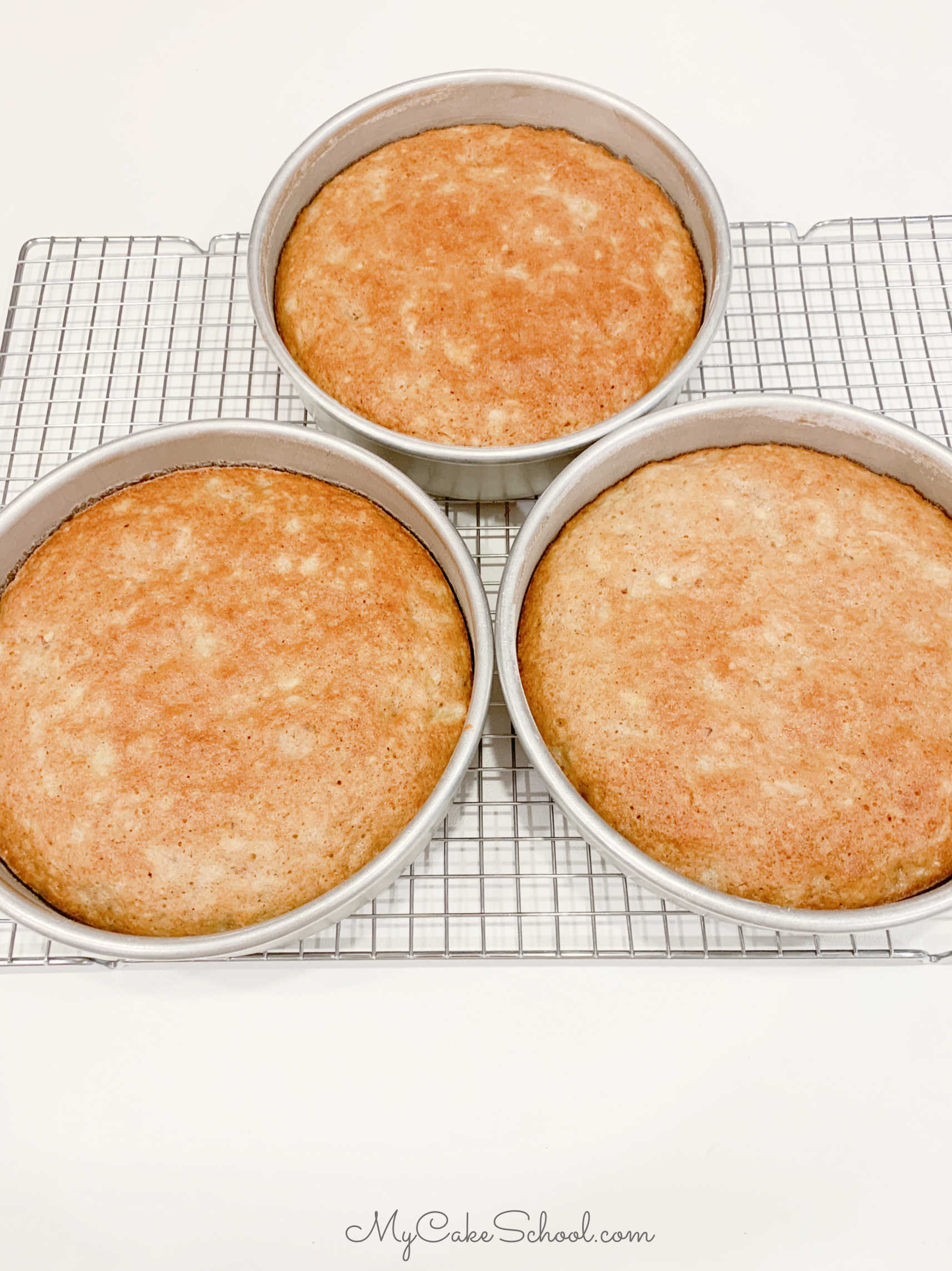 Hummingbird Cake Layers, cooling in pans on a wire rack.