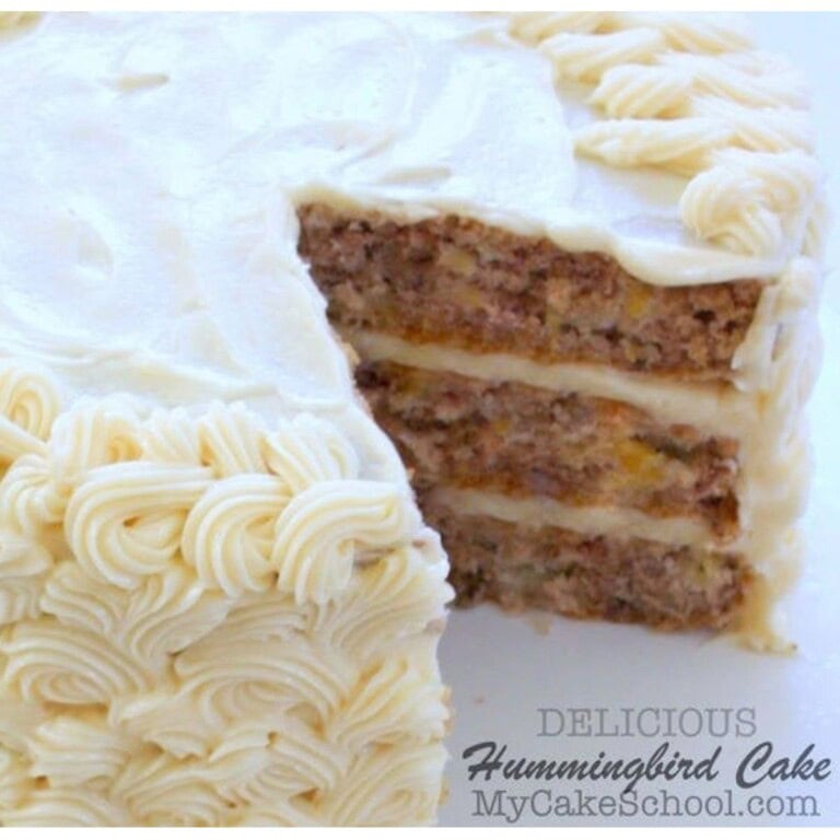 Sliced Hummingbird Cake on a cake pedestal.