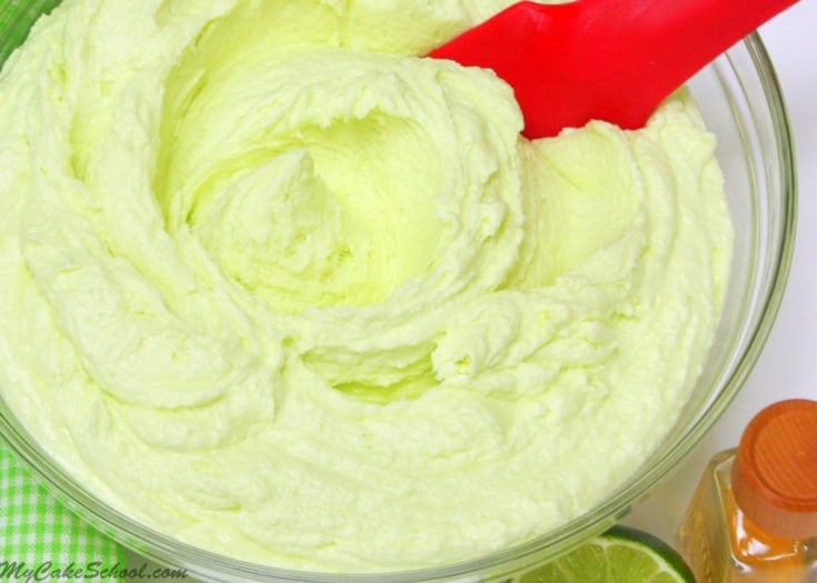 Tequila Lime Buttercream in a glass bowl with red spatula.