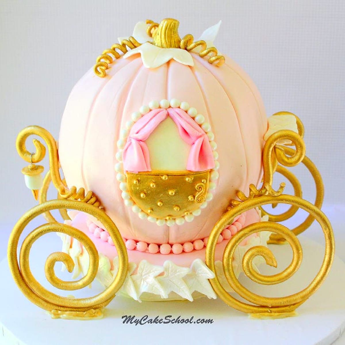 Pink Cinderella Carriage Cake with gold gum paste wheels and accents.