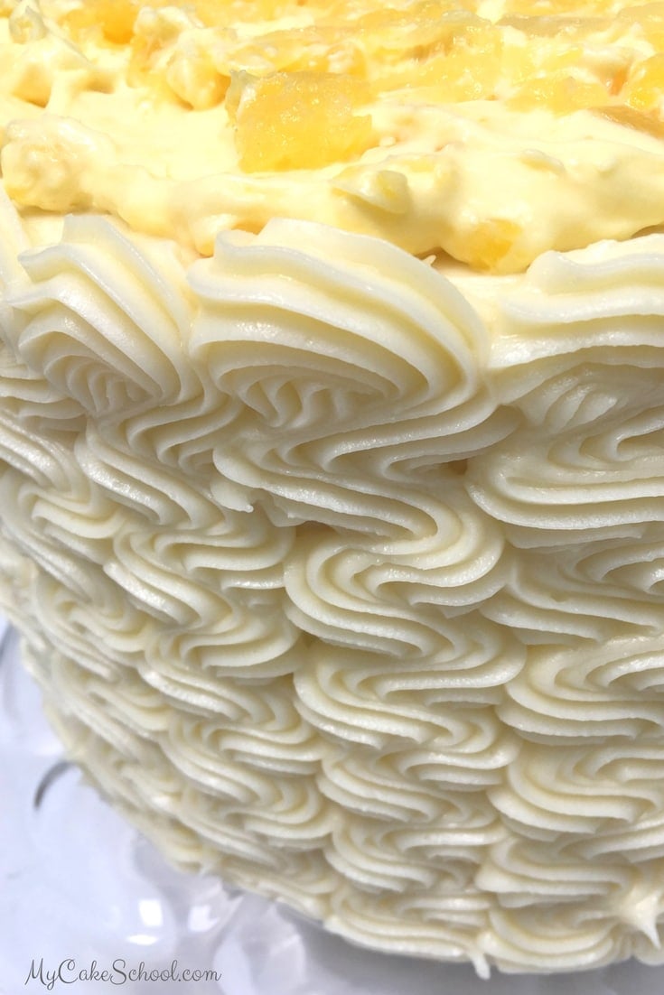 AMAZING Pineapple Cake Recipe with moist yellow cake layers, pineapple cream filling, and cream cheese frosting! MyCakeSchool.com.