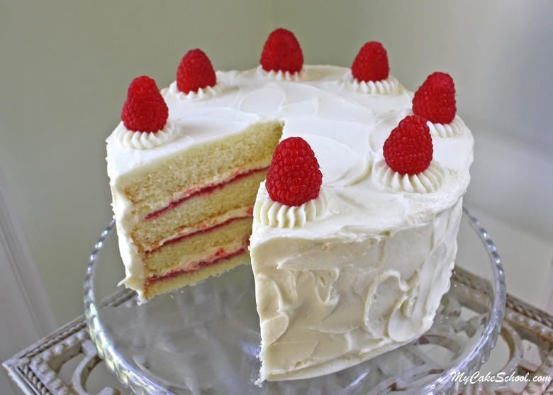 This White Chocolate Raspberry Cake Recipe is the BEST! Homemade white chocolate cake layers with raspberry filling and White Chocolate Buttercream!