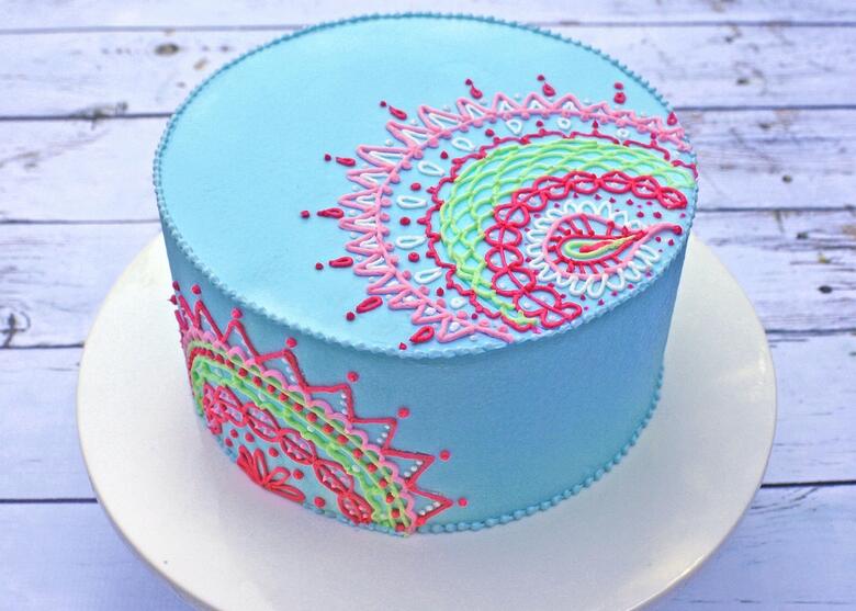 Learn how to create beautiful henna inspired buttercream piping for your cakes in this MyCakeSchool.com video tutorial!