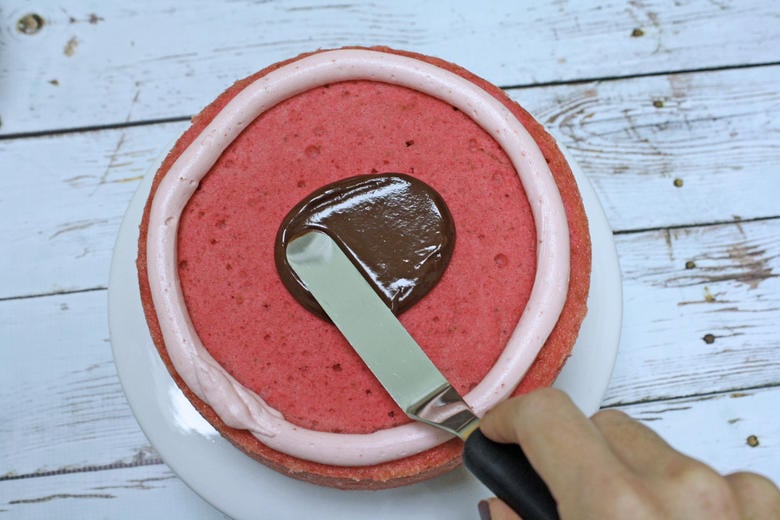 Chocolate Covered Strawberry Cake Recipe by MyCakeSchool.com- Spreading a thin ganache glaze.