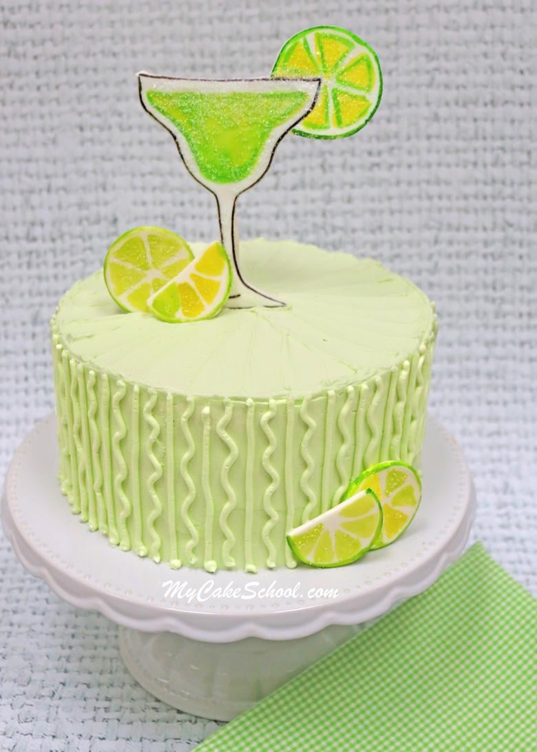 This Margarita Cake is SO simple to make and is amazingly moist and flavorful! We've frosted it in an irresistible Tequila Lime Buttercream Frosting and have topped it with a custom Margarita glass cake topper! Learn to make it in our simple tutorial! Delicious Margarita Cake- A doctored cake mix recipe! This easy and delicious recipe with Tequila Lime Buttercream is perfect for Cinco de Mayo!