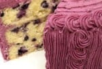Lemon Blueberry Cake, sliced, on a cake pedestal.