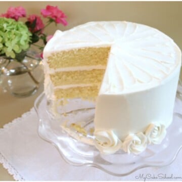 Sliced Vanilla Buttermilk Cake on a glass pedestal.