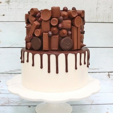 Candy Bar Drip Cake on White Pedestal