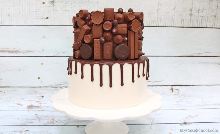 Candy Bar Drip Cake on White Pedestal