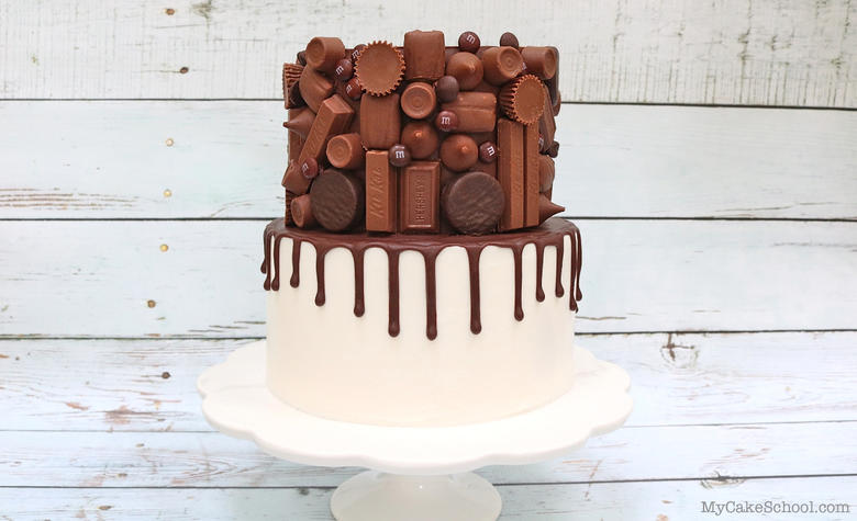 Candy Bar Drip Cake on White Pedestal 