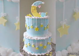 Learn how to make this adorable Baby and Moon Cake Tutorial by MyCakeSchool.com, featuring a moon and stars as well as a CUTE cake topper!