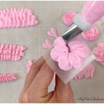 Piping a buttercream flower on a rose nail.