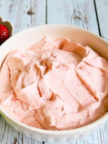 White Bowl filled with pink Strawberry Whipped Cream Cheese filling.