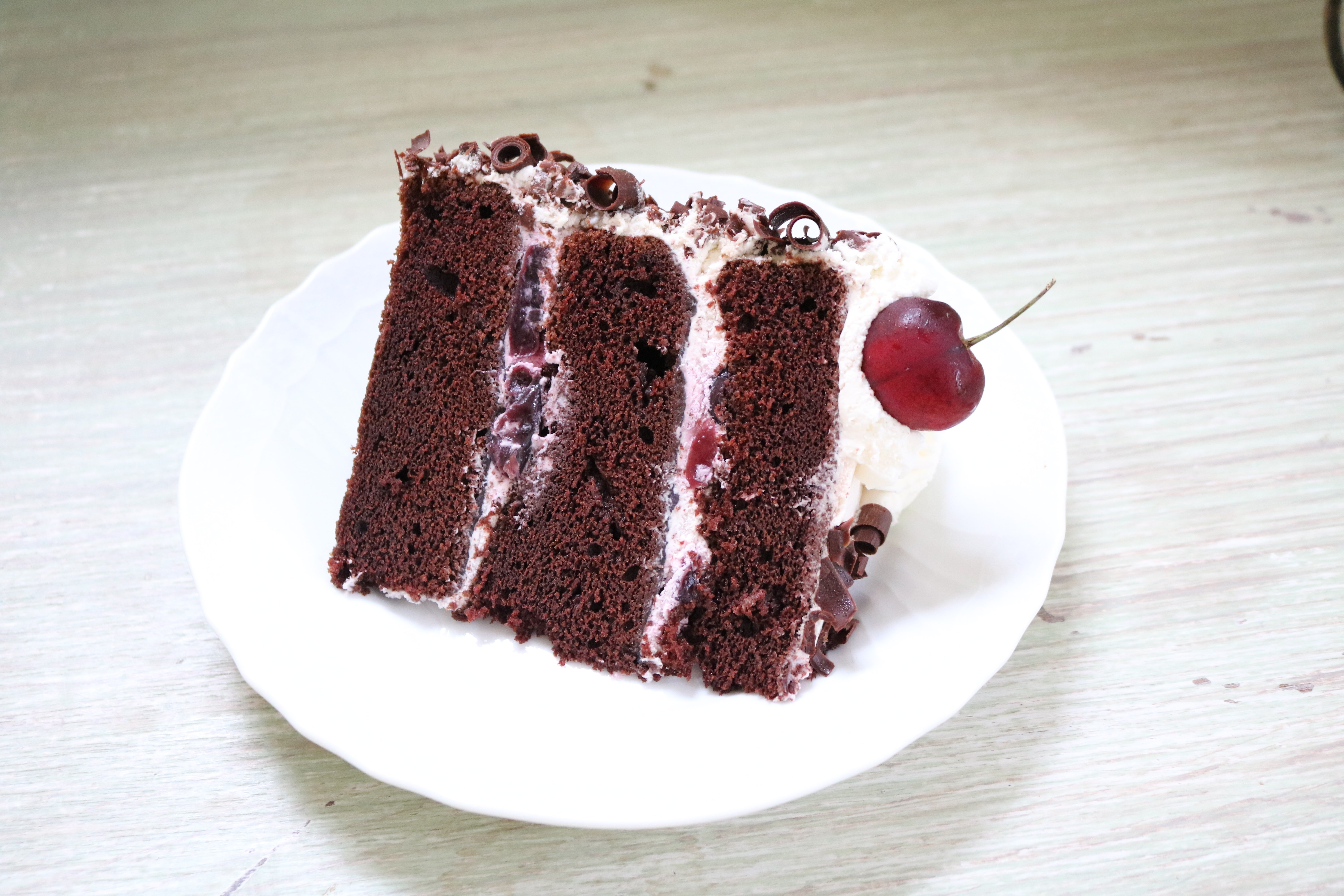 This Black Forest Cake From Scratch is the Best! Chocolate cake infused with Cherry Liqueur and filled with whipped cream and cherries!