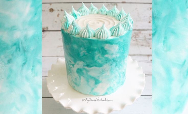 Blue and white marbled buttercream cake on white pedestal