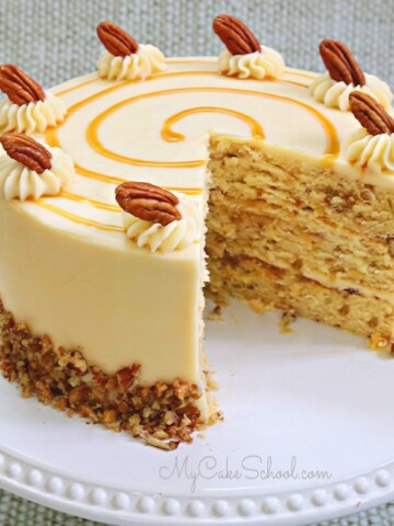 Toffee Pecan Caramel Cake on white pedestal